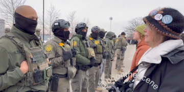 Border Patrol Agent Embraces Protester During Minnesota Immigration Demonstration