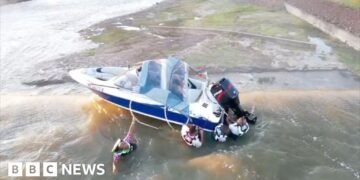 Four Men Rescued from Boat on Brink of Dam Edge in Dramatic Operation
