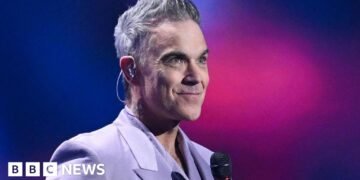 Robbie Williams Reflects on British Self-Devaluation in Recent Interview